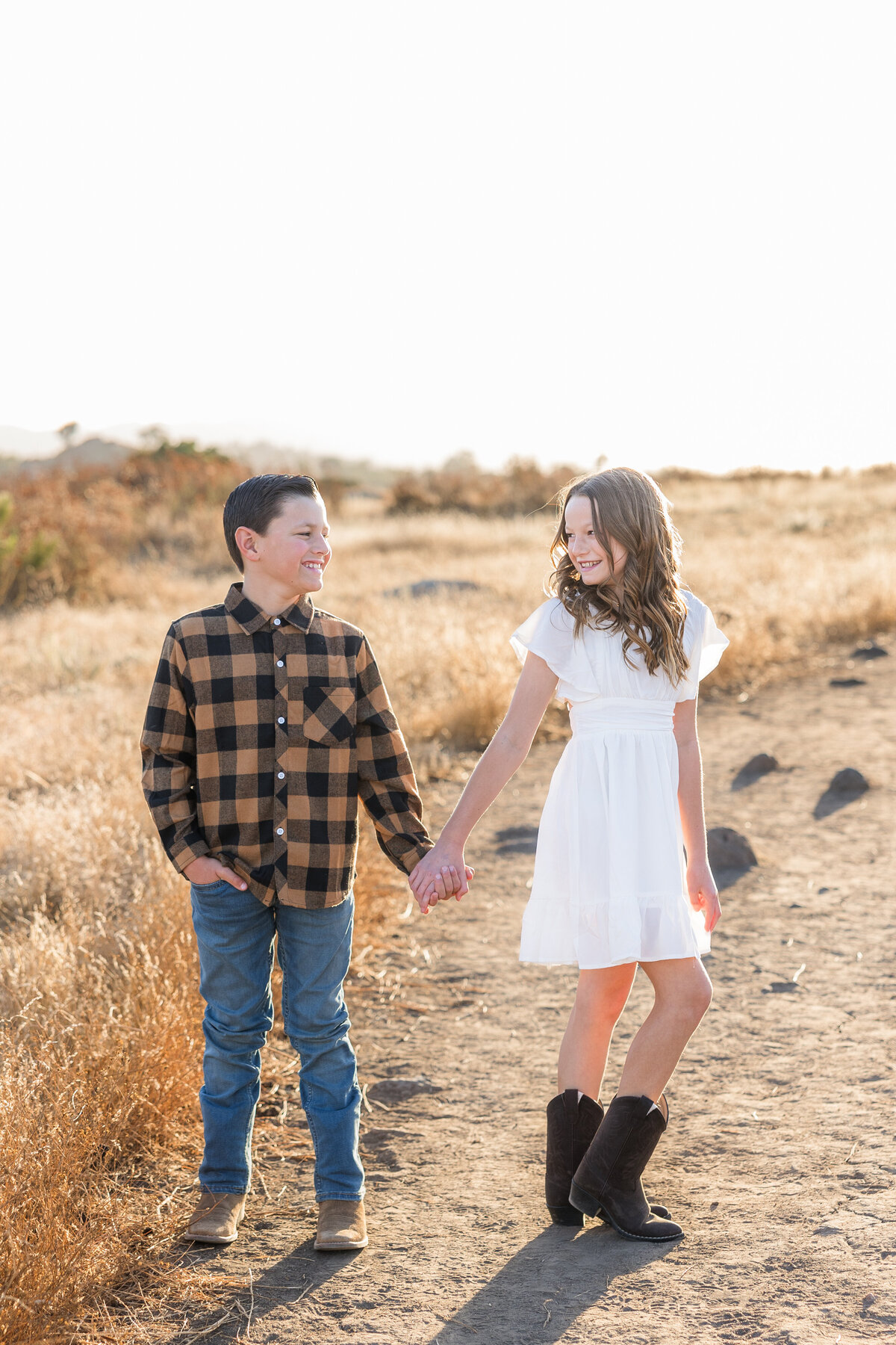 brother and sister standing in wrights field
