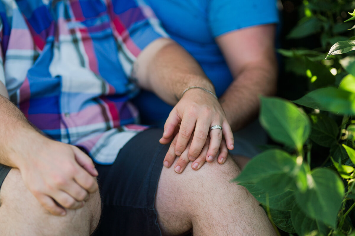 Detail of a couple holding hands at their engagement session in Rochester