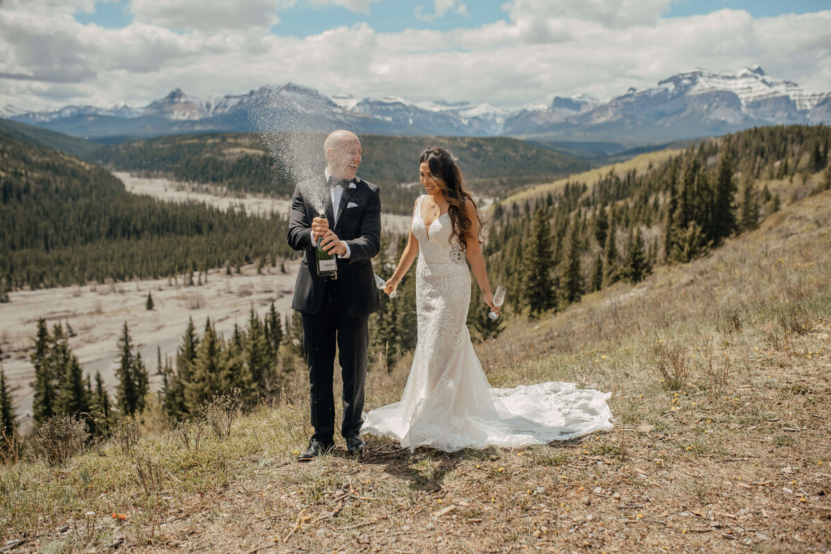 Bride and groom celebrating with mountain views