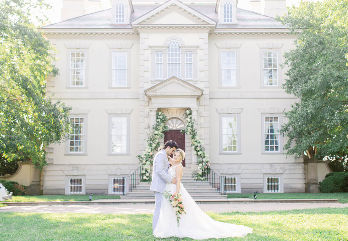 Bride and Groom standing in front of Great Marsh Estate. Taken by Bethany Aubre Photography.