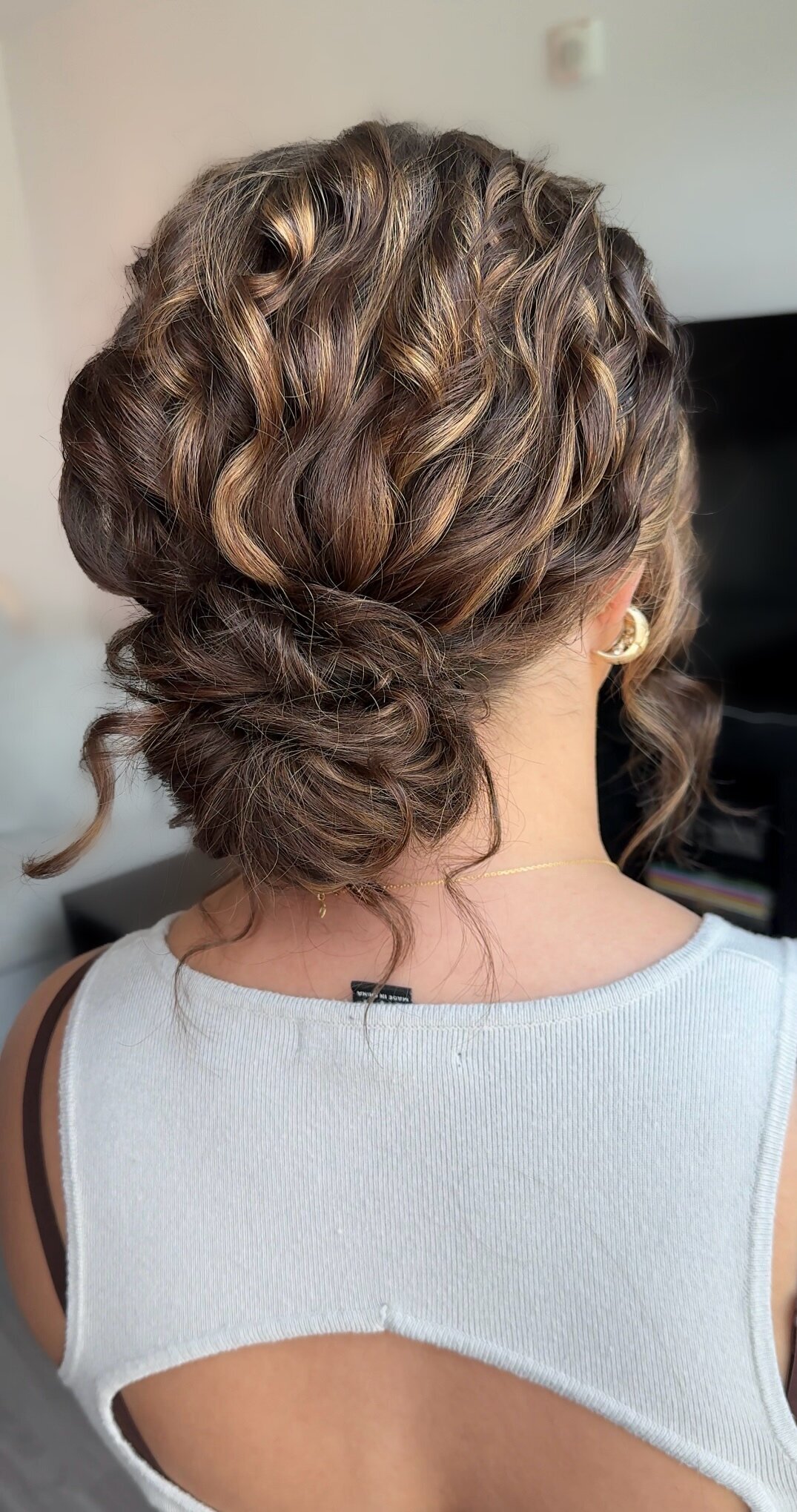 messy low updo bun for dark hair