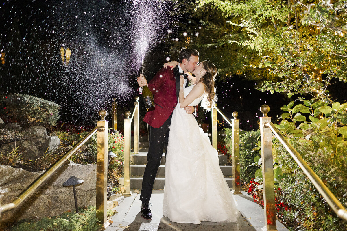 Champagne bottle pop photo at night during Abbey Inn & Spa wedding in Peekskill, NY