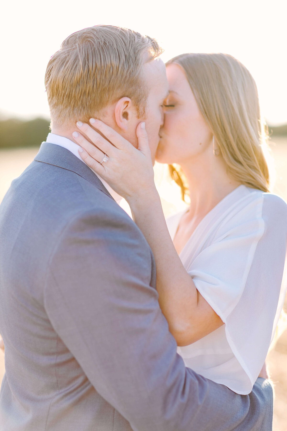 Woman dressed in white dress for engagement session