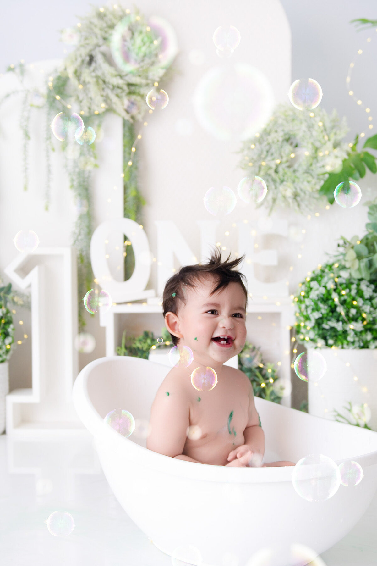 baby bly turning one playing in milkbath blowing bubbles