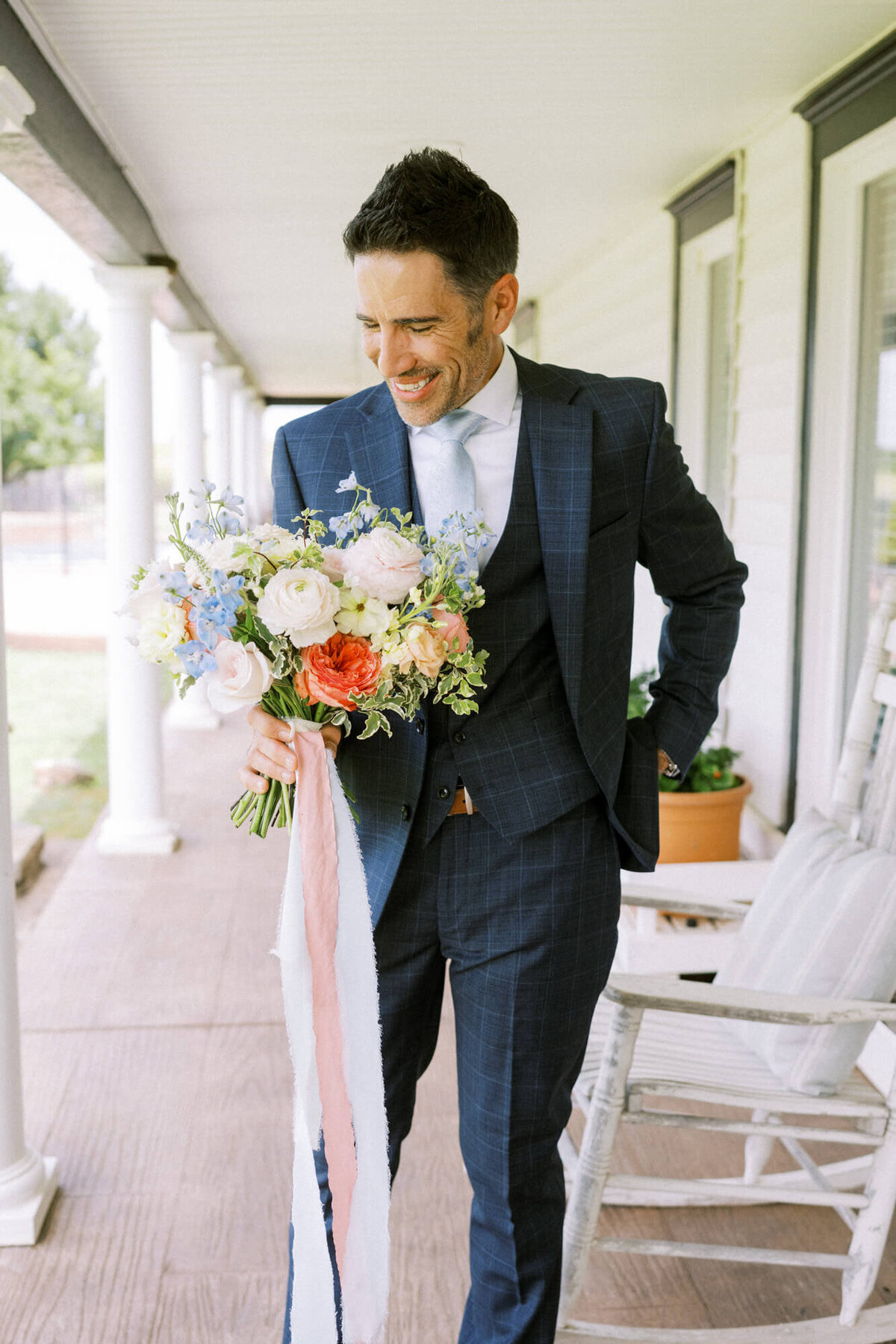 groom-holding-bridal-bouquet