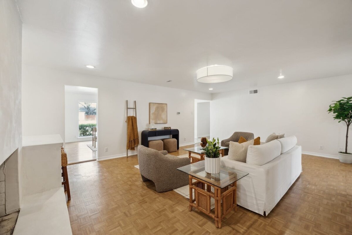 3120 Chapel Downs Dr Dallas TX living room showcasing natural light, parquet wood flooring, and cozy neutral decor — listed by Haven Realty Group.