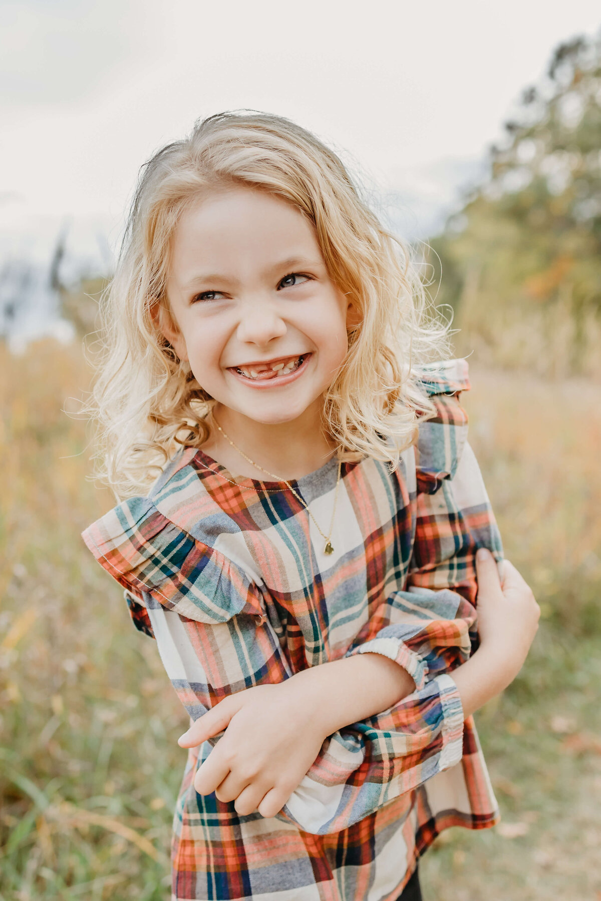 portrait of blond girl in plaid