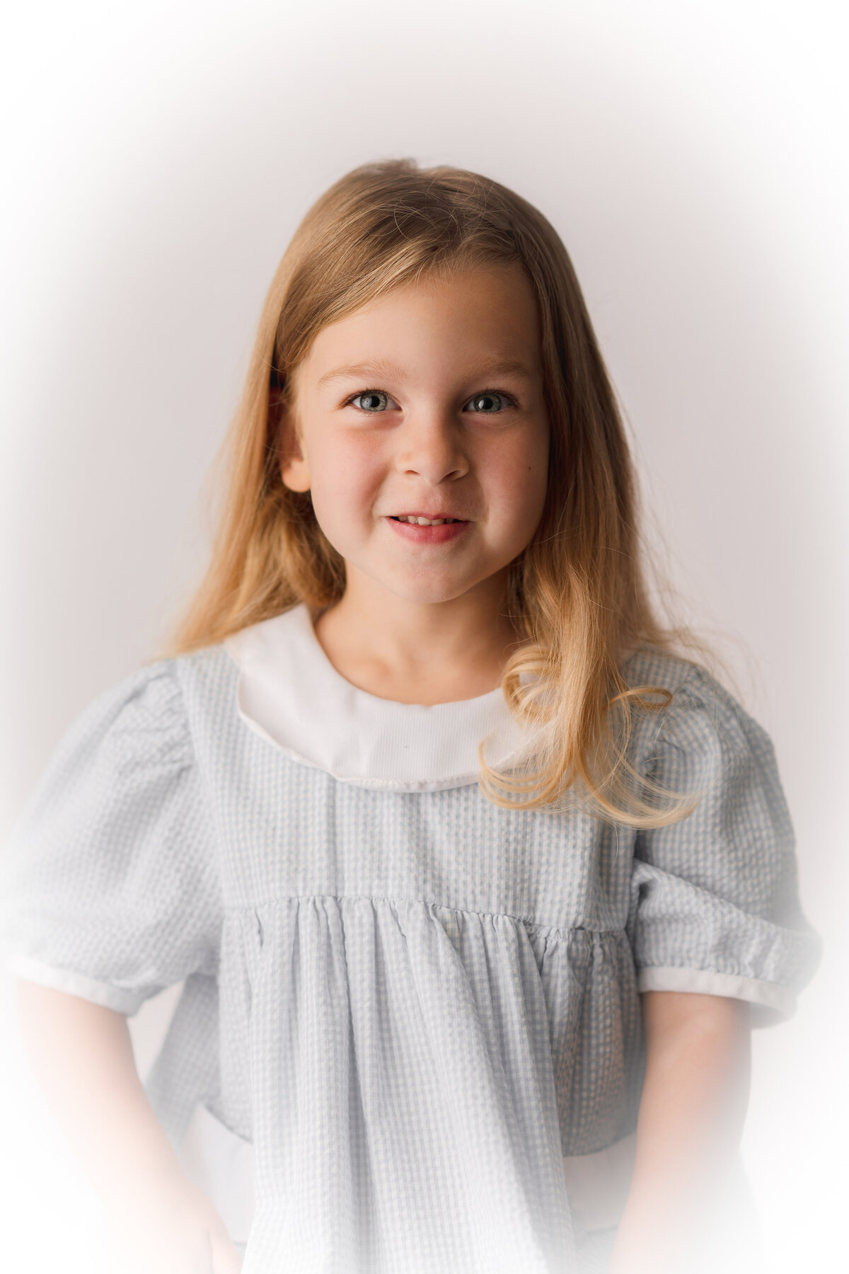 Little girl smiles at the camera during Classic Heirloom Portrait Session in Charleston, SC. 