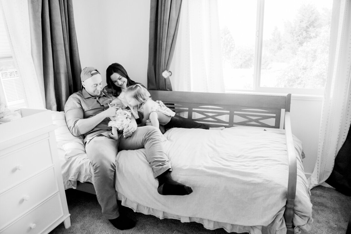 family on bed with baby