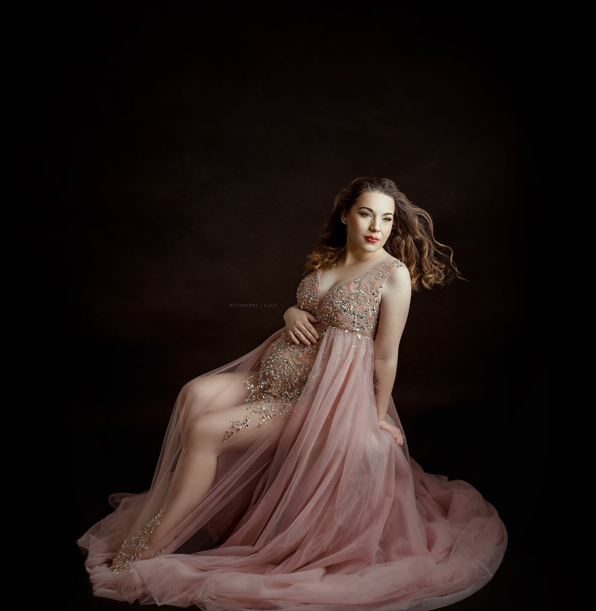 maternity in oswego ny studio wearing a pink gown