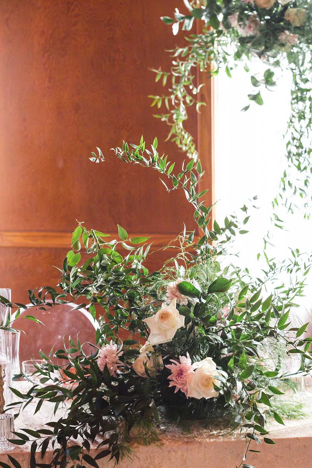 a white and pink flower arrangement sitting on a table