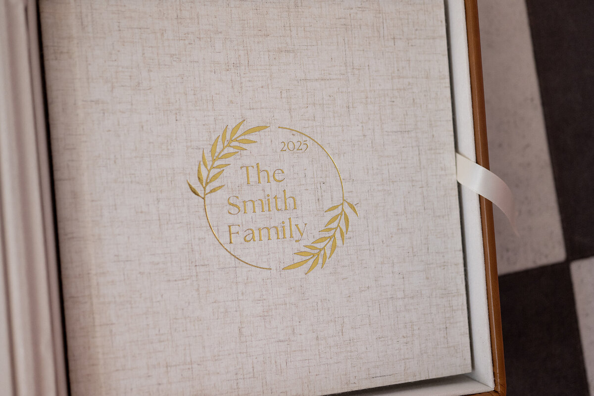 A linen album for the Smith Family was put together by a Pella Family Photographer