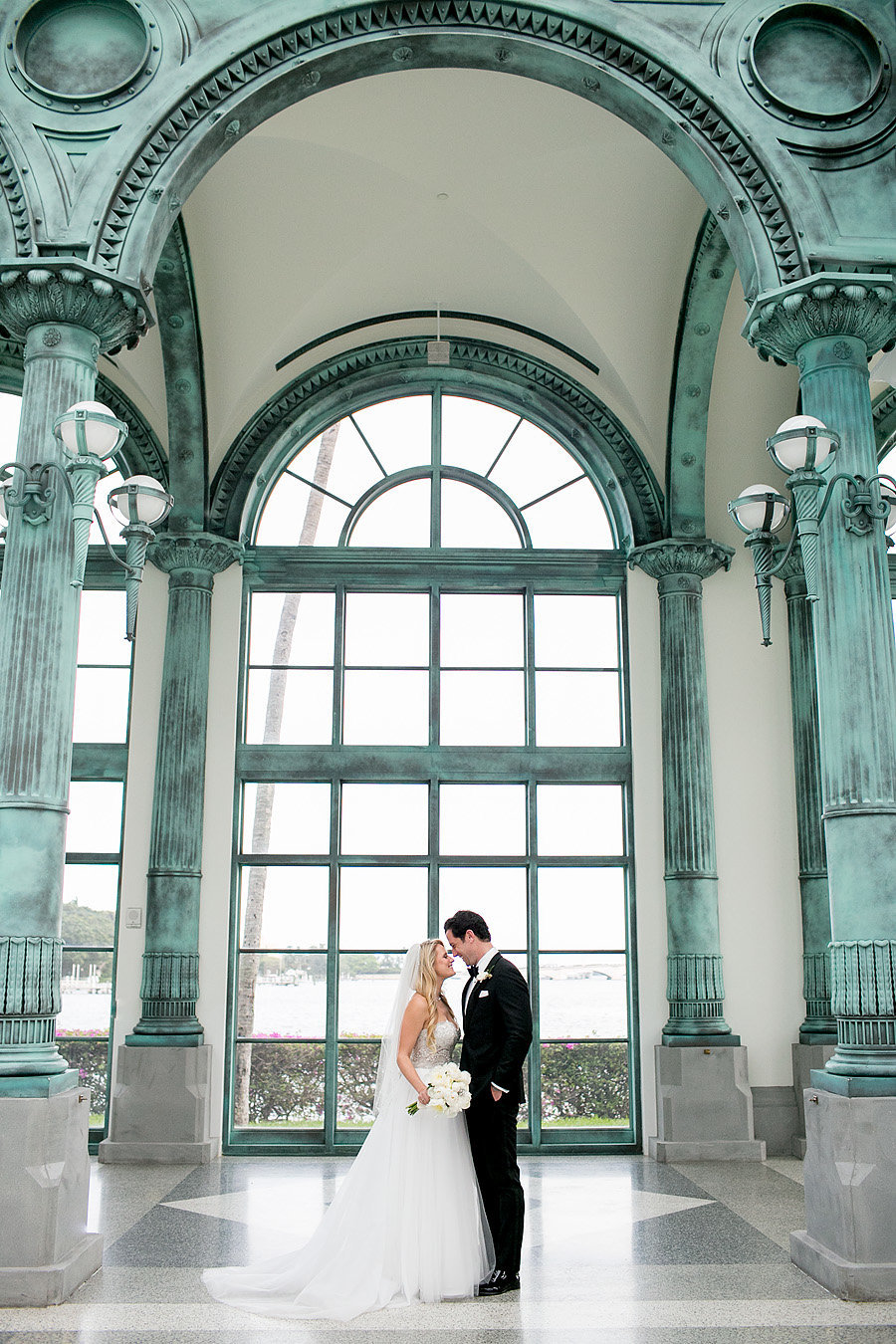 bride and groom standing in pavilion of flagler museum