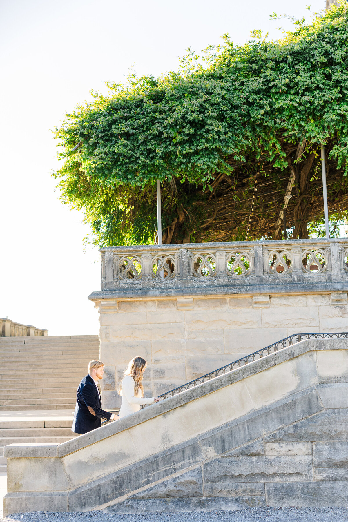 Couple walking up stairs at the Biltmore during their engagement session