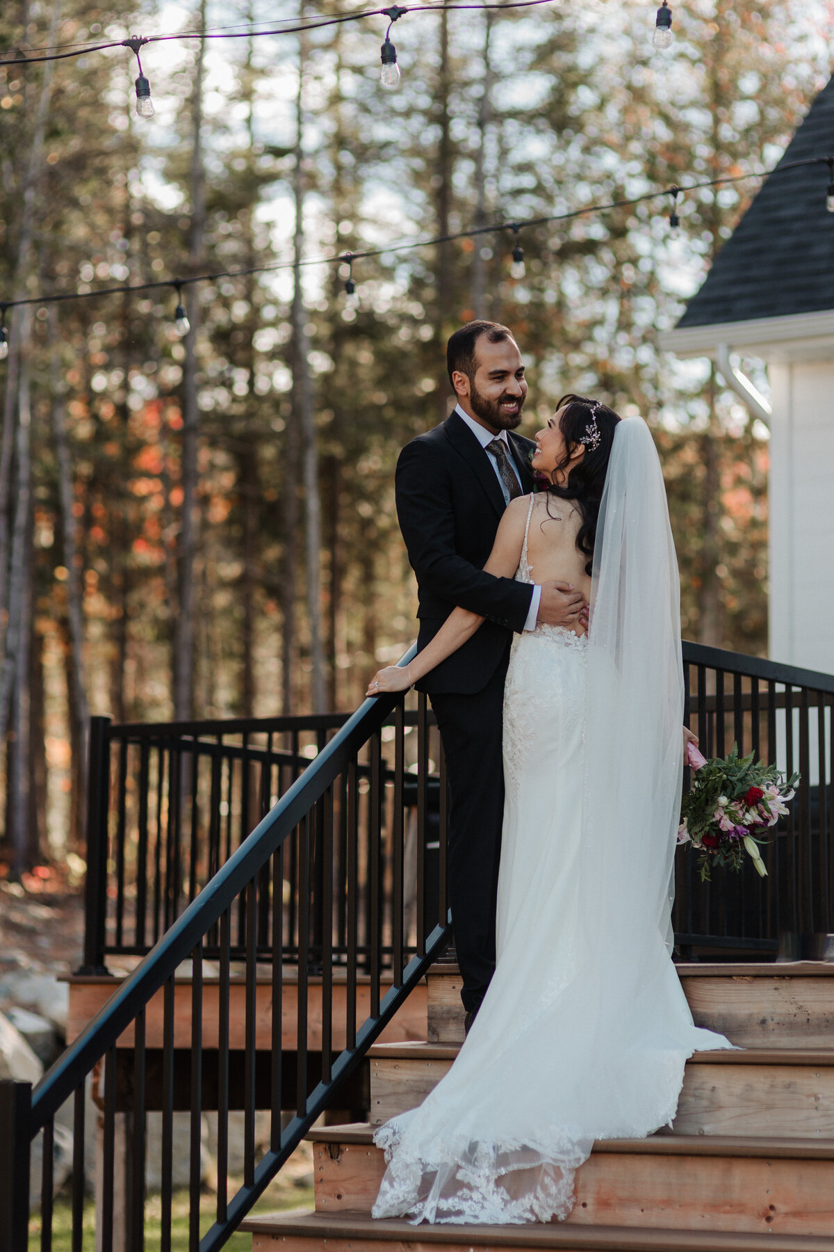 Romantic autumn wedding portrait with bride and groom in golden leaves