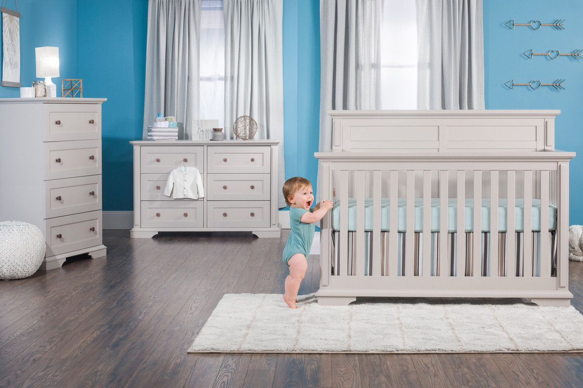 Advertising photograph of a child model with a crib