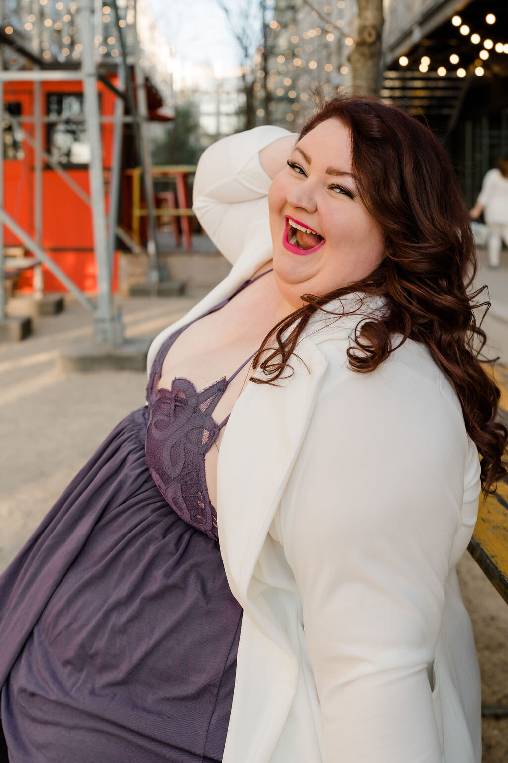 woman laughing while holding her head with one hand