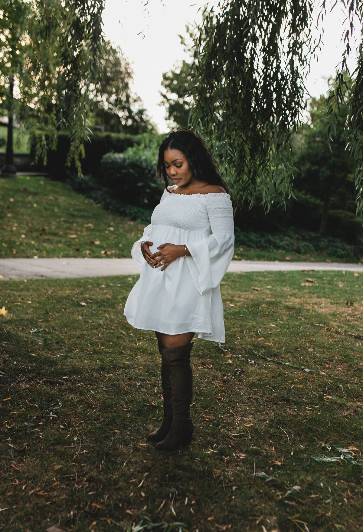 Maternity shot with soon to be mom wearing white dress.