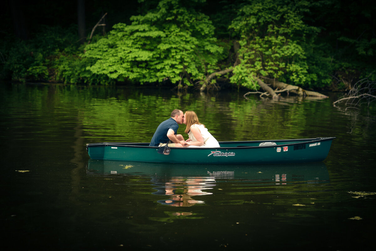 couple kisses in canoe 