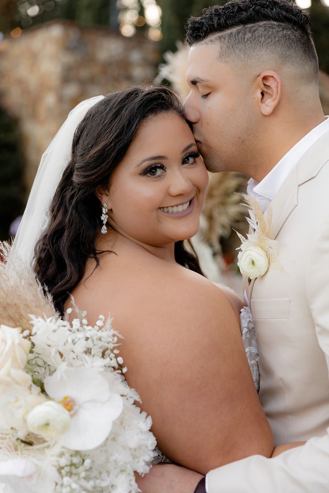 Groom kissing brides forehead at Bella Collina in Montverde, Fl