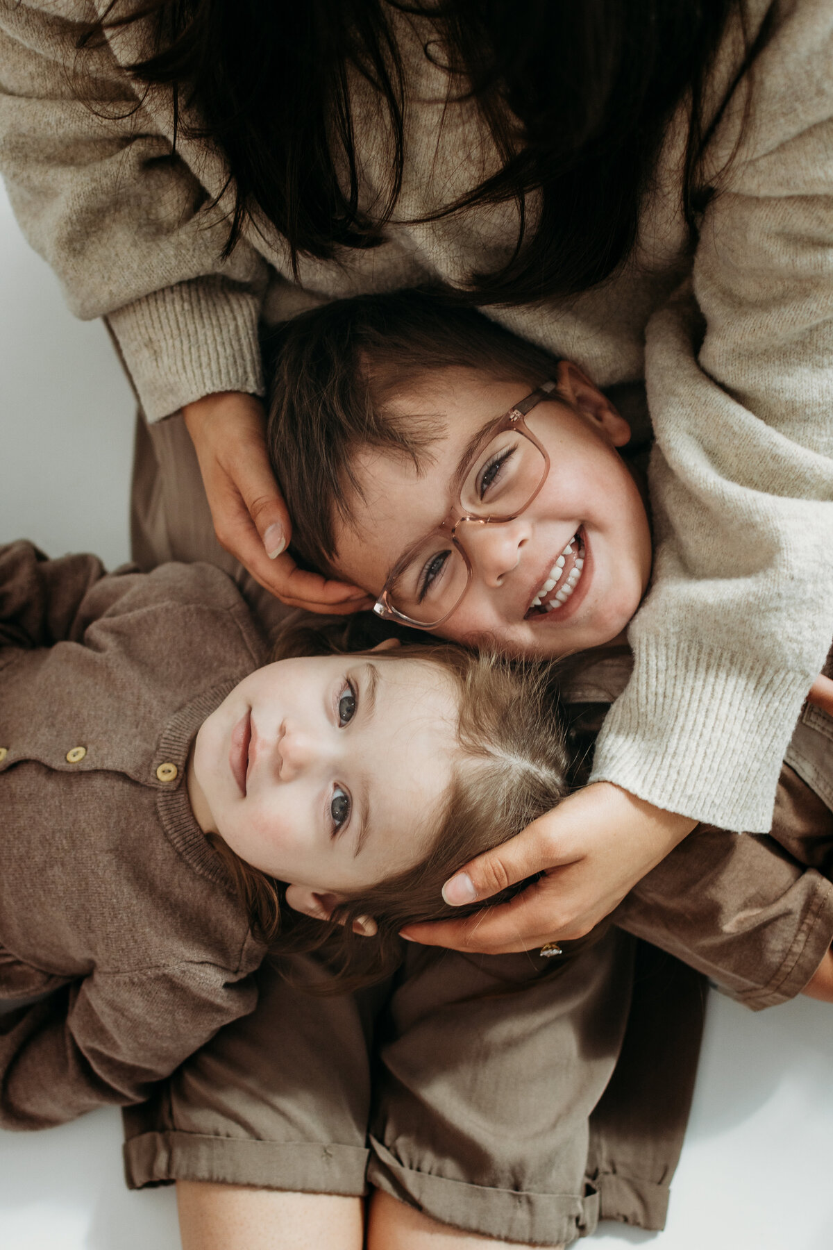 Moms perspective of her two small children during a motherhood photoshoot in a studio in Bartlett, IL