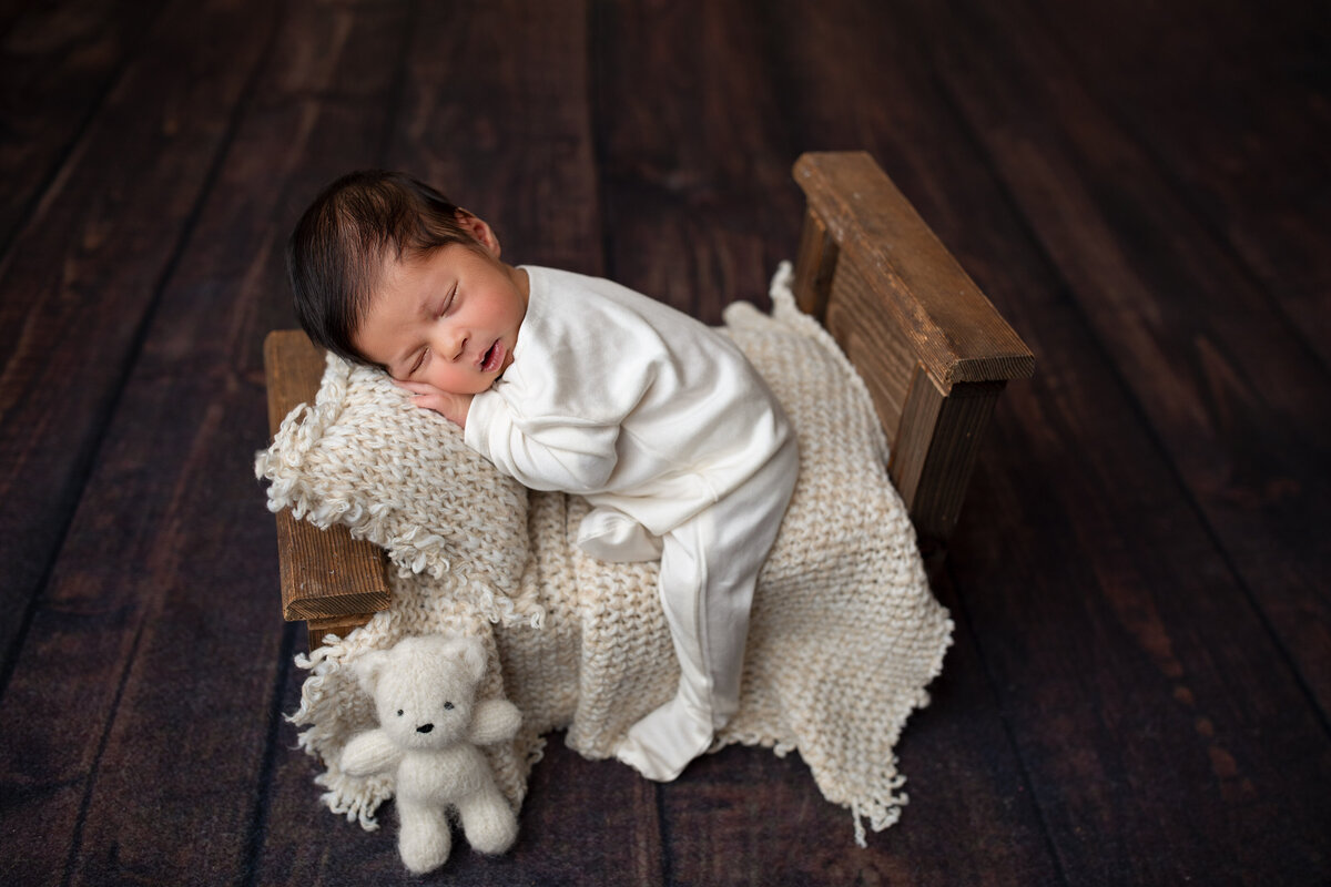 sleeping newborn baby boy in white