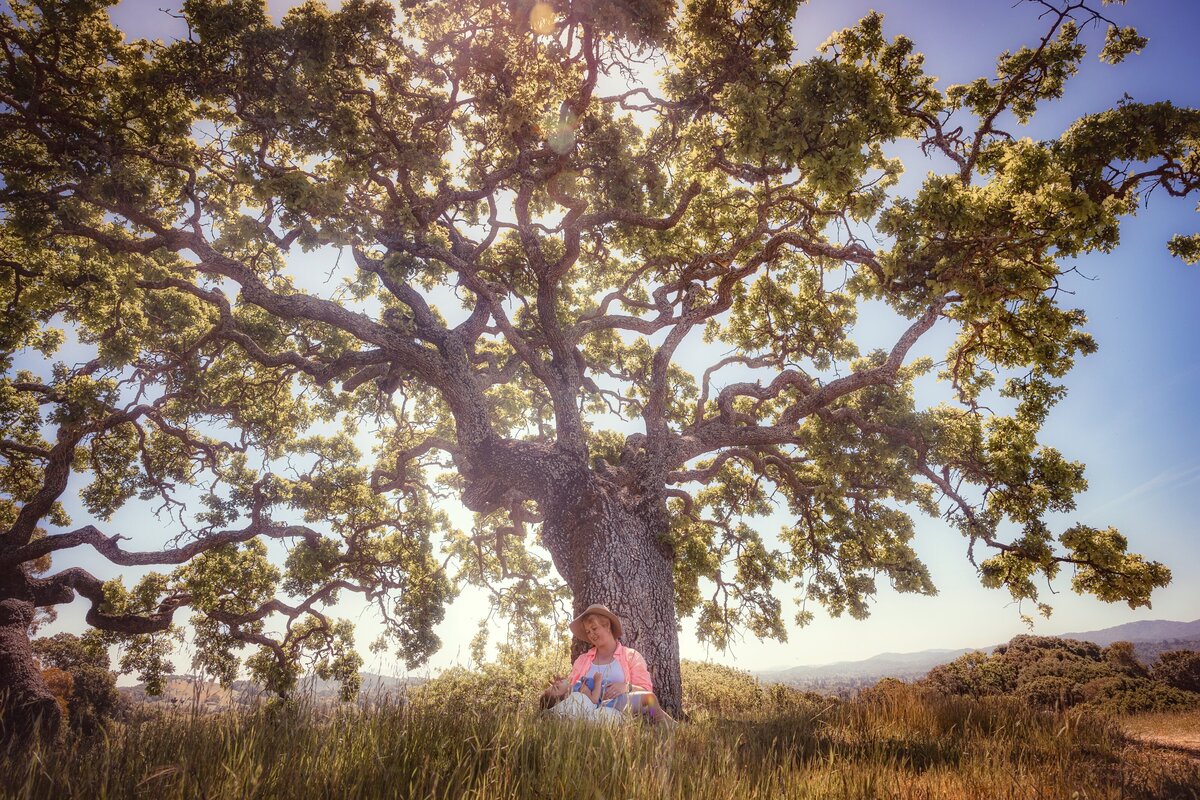 woman and child by oak tree