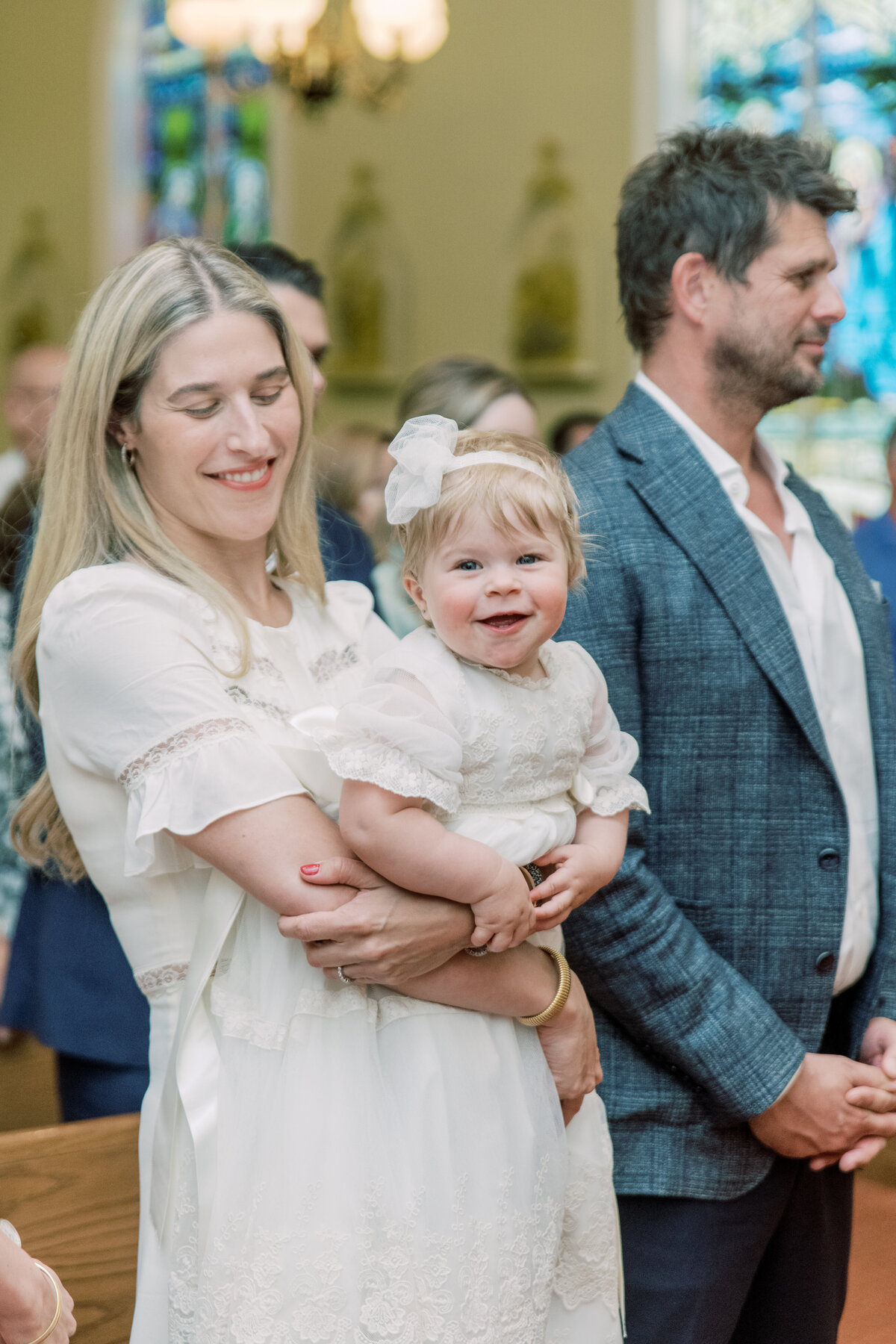Heartfelt moment inside the church, baby glowing in her lace dress as the ceremony unfolds.

