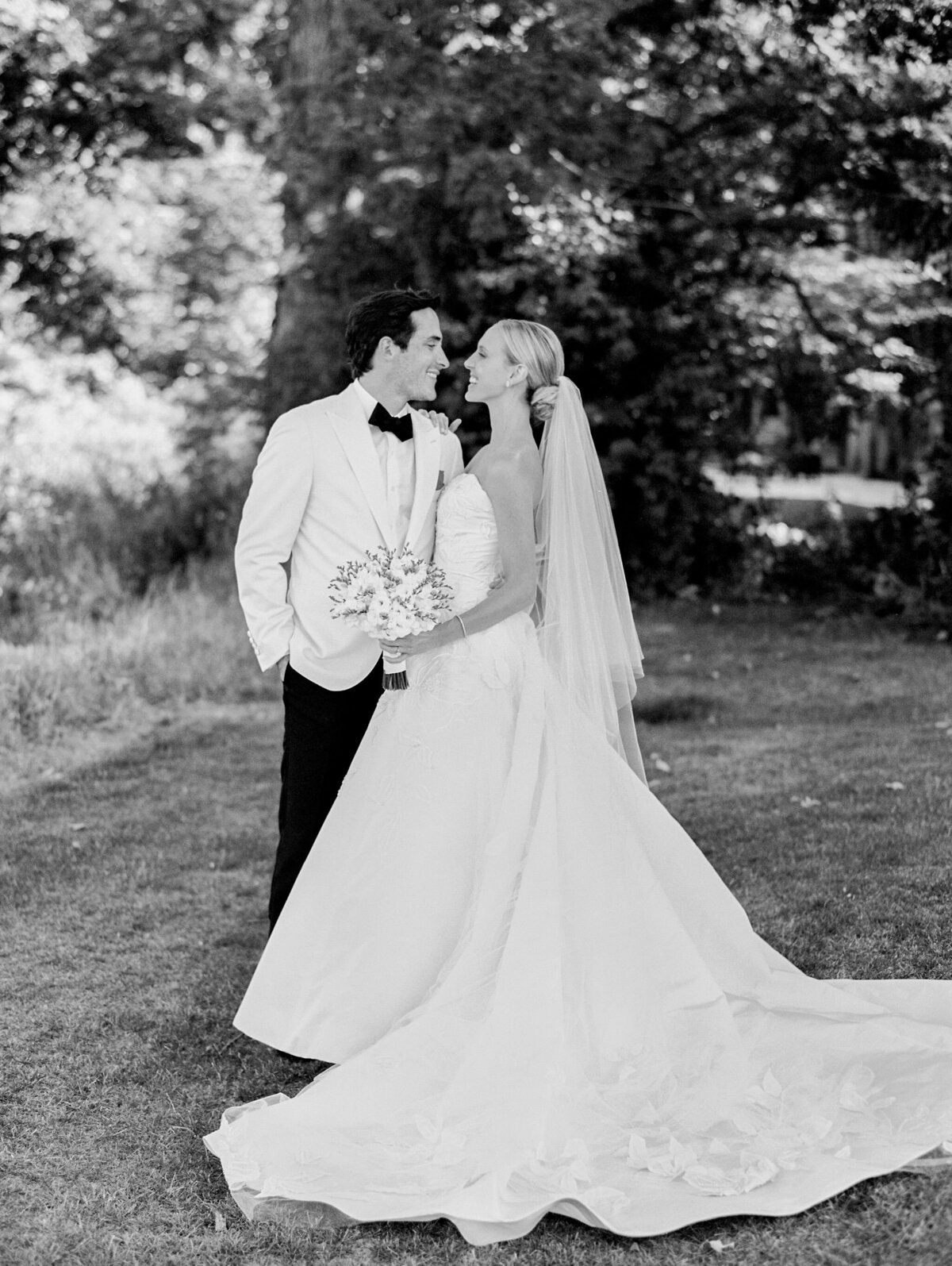 Black and white photo of the bride and groom looking into each others eyes. 