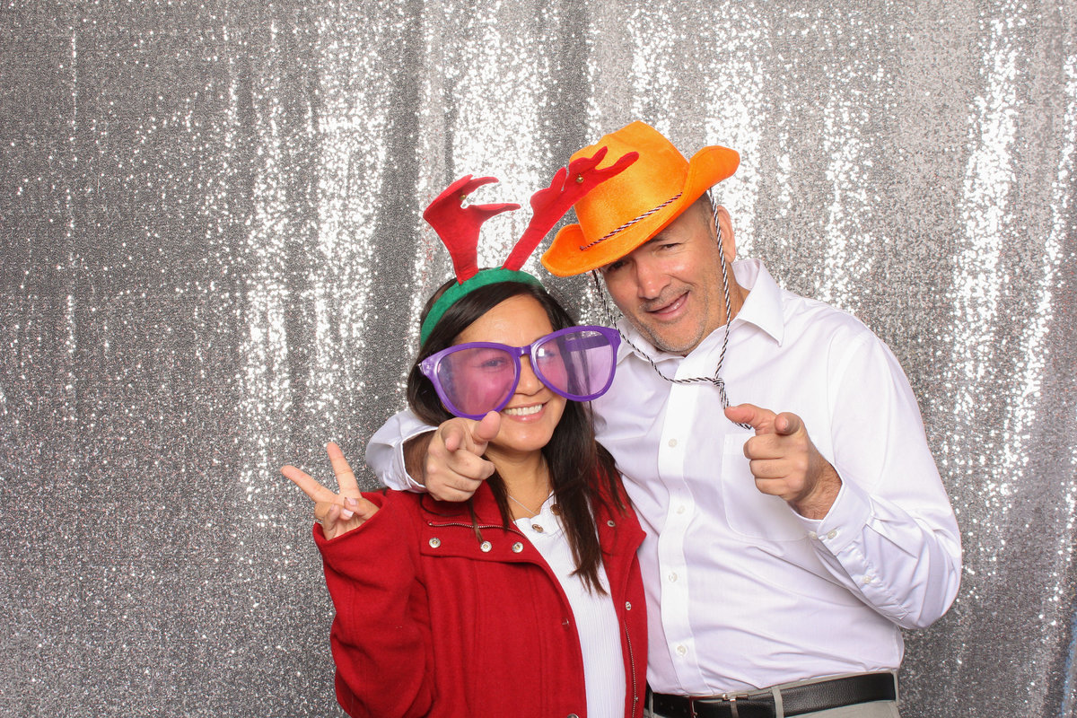 Fun couple hamming it up in a photo booth rental from Three16 Photography