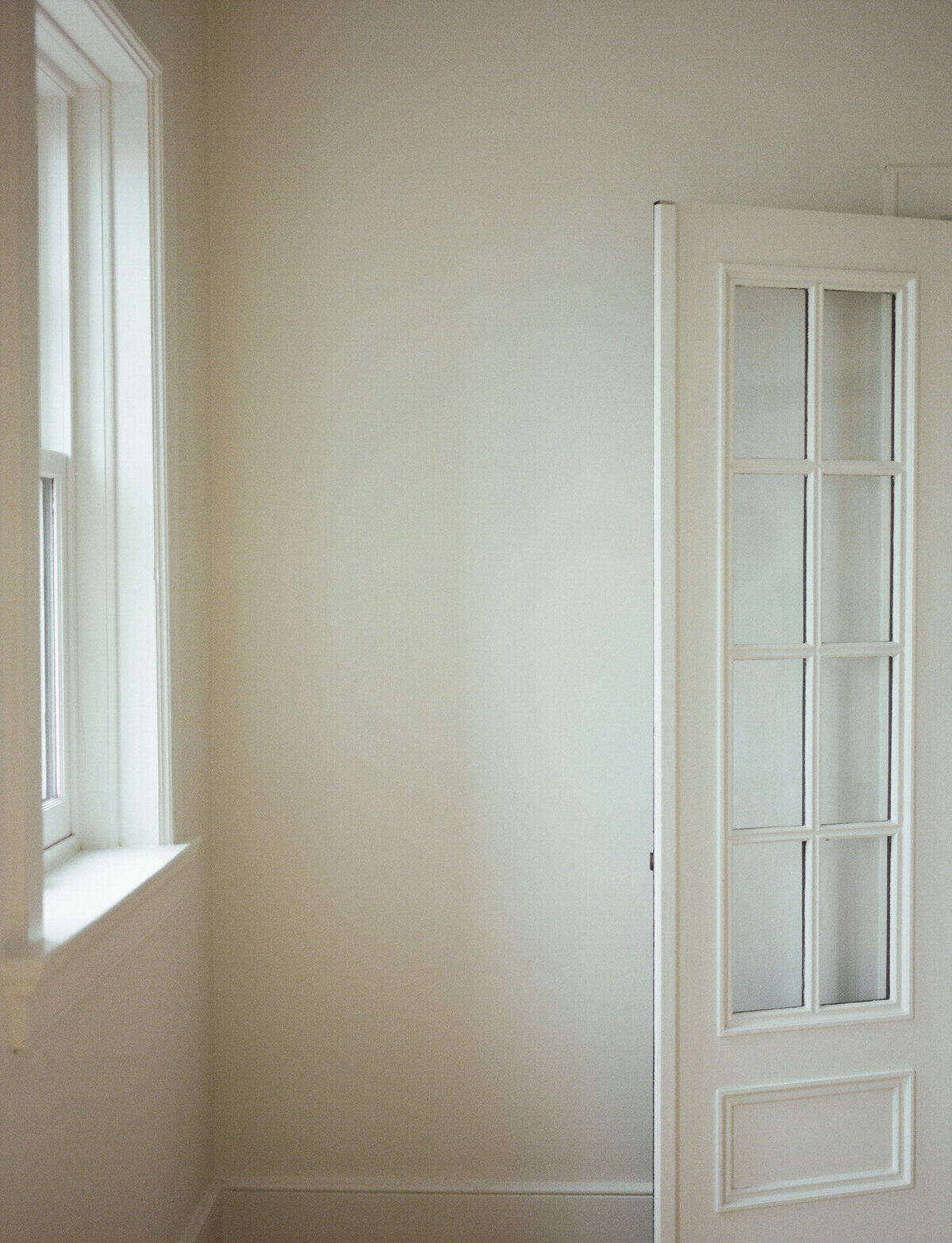 Warm white room with character, door, historic detail, ALEO Detroit