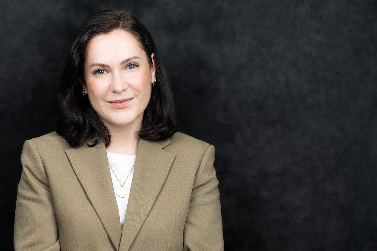 Headshot of a business woman wearing a beige blazer