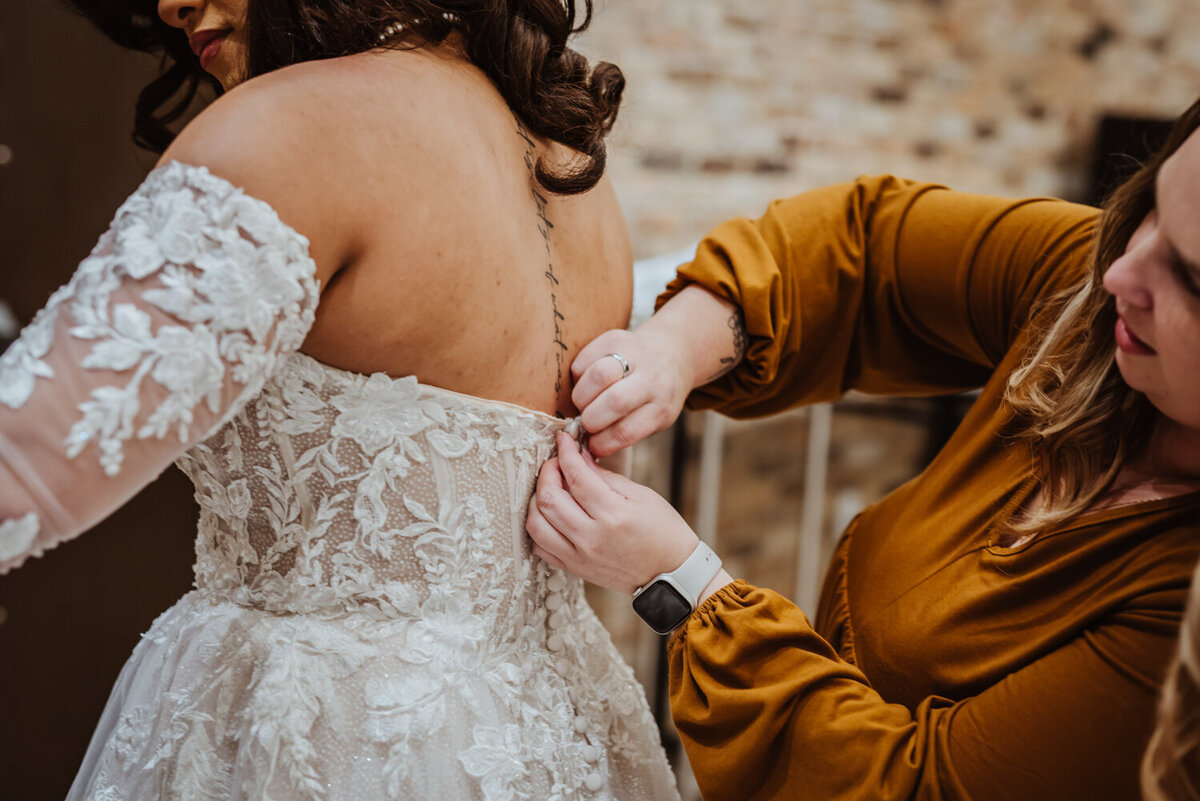 bride-getting-dressed-wedding-day-detail-surety-hotel-des-moines-iowa-storyteller-collective-photo-co