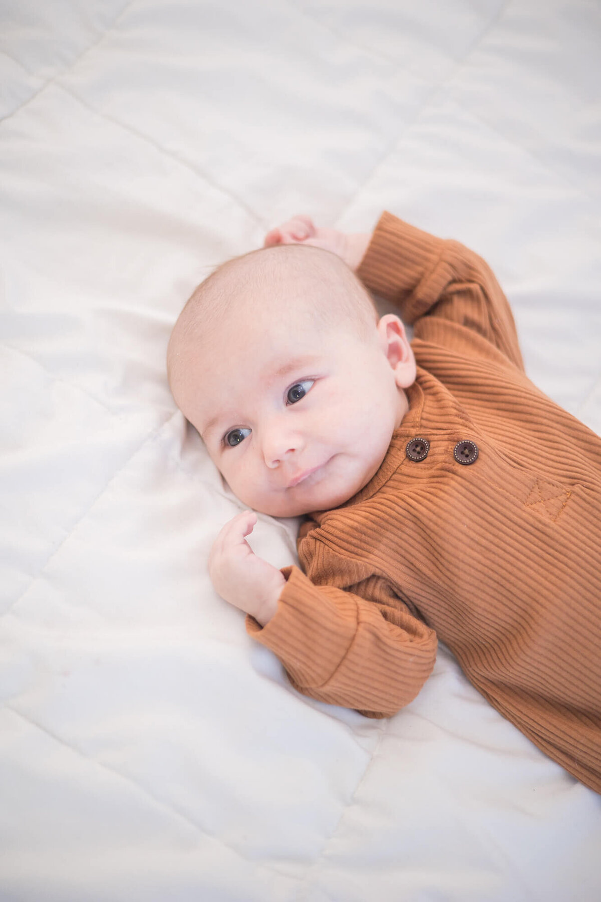 newborn baby boy watching something off to the side