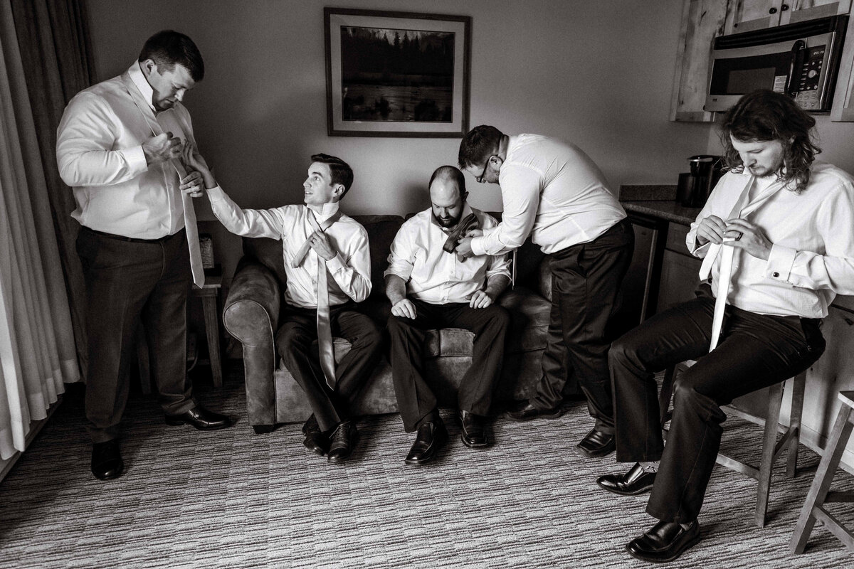 Shannon Lee, from Love Like Wild Photography, captures a candid moment of groomsmen helping each other get ready before the ceremony.
