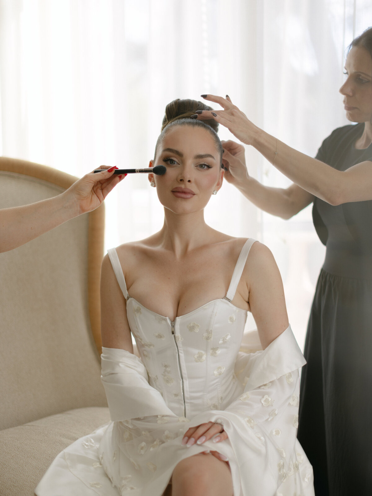 Bride getting hair and makeup done