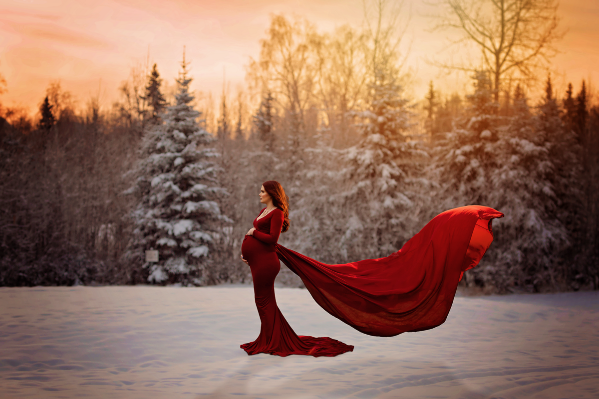Embrace maternity bliss with our winter session near San Antonio. Laid-back parents, our mom-to-be's scarlet flying dress creates a scene of beauty and warmth in the winter field.