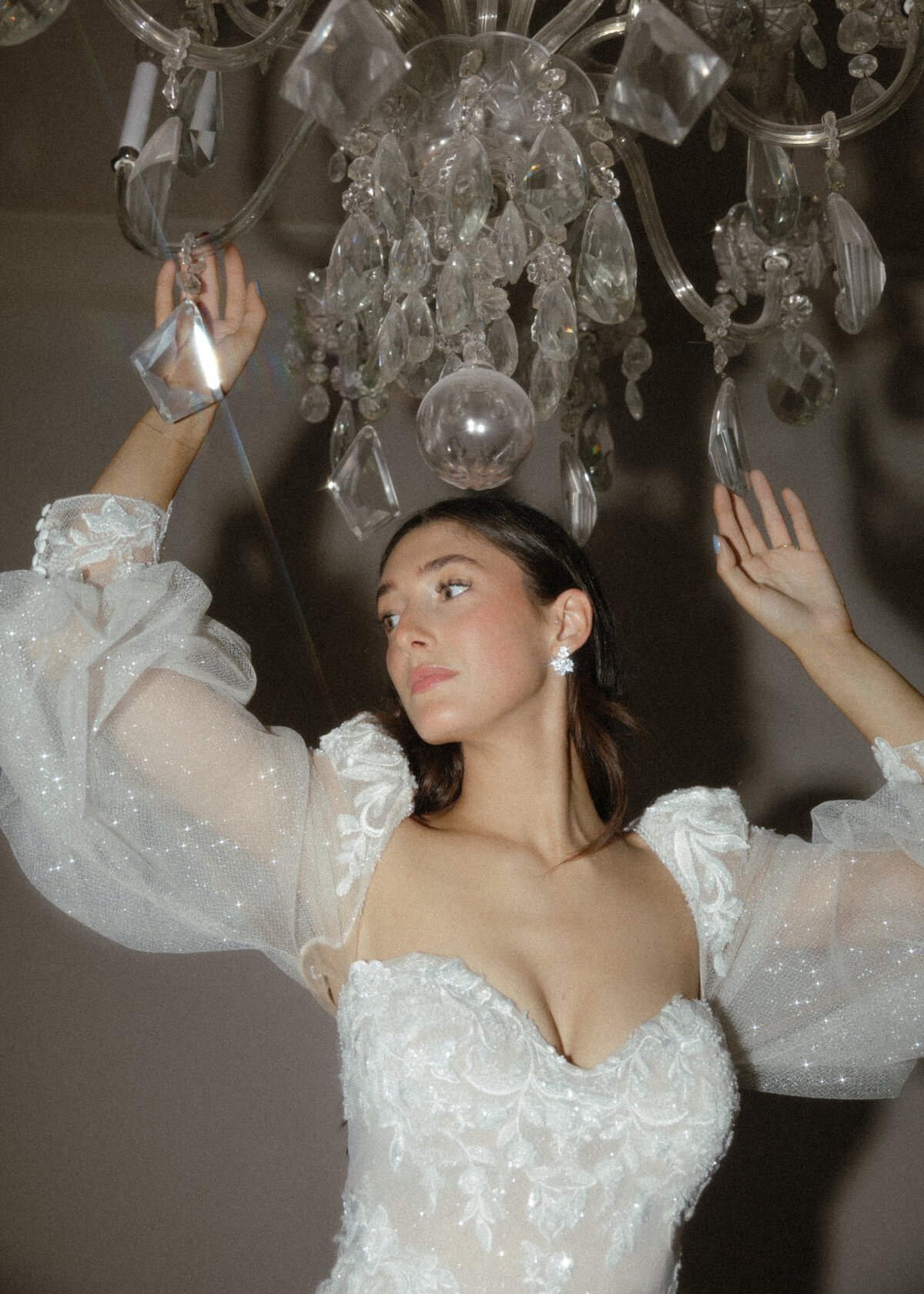Dazzled in diamonds and styled to perfection, photographs of the bride amongst a chandelier.