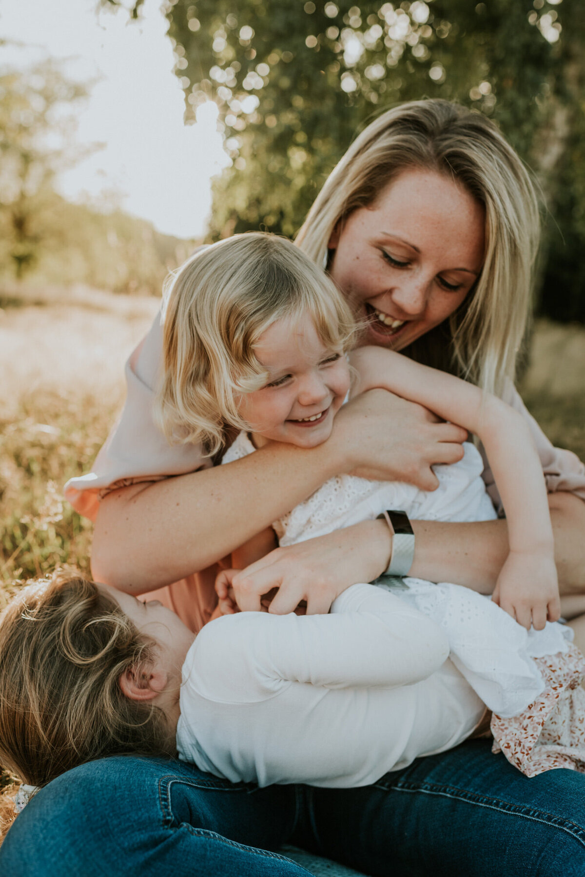 Family portrait with mother and two giggling toddlers