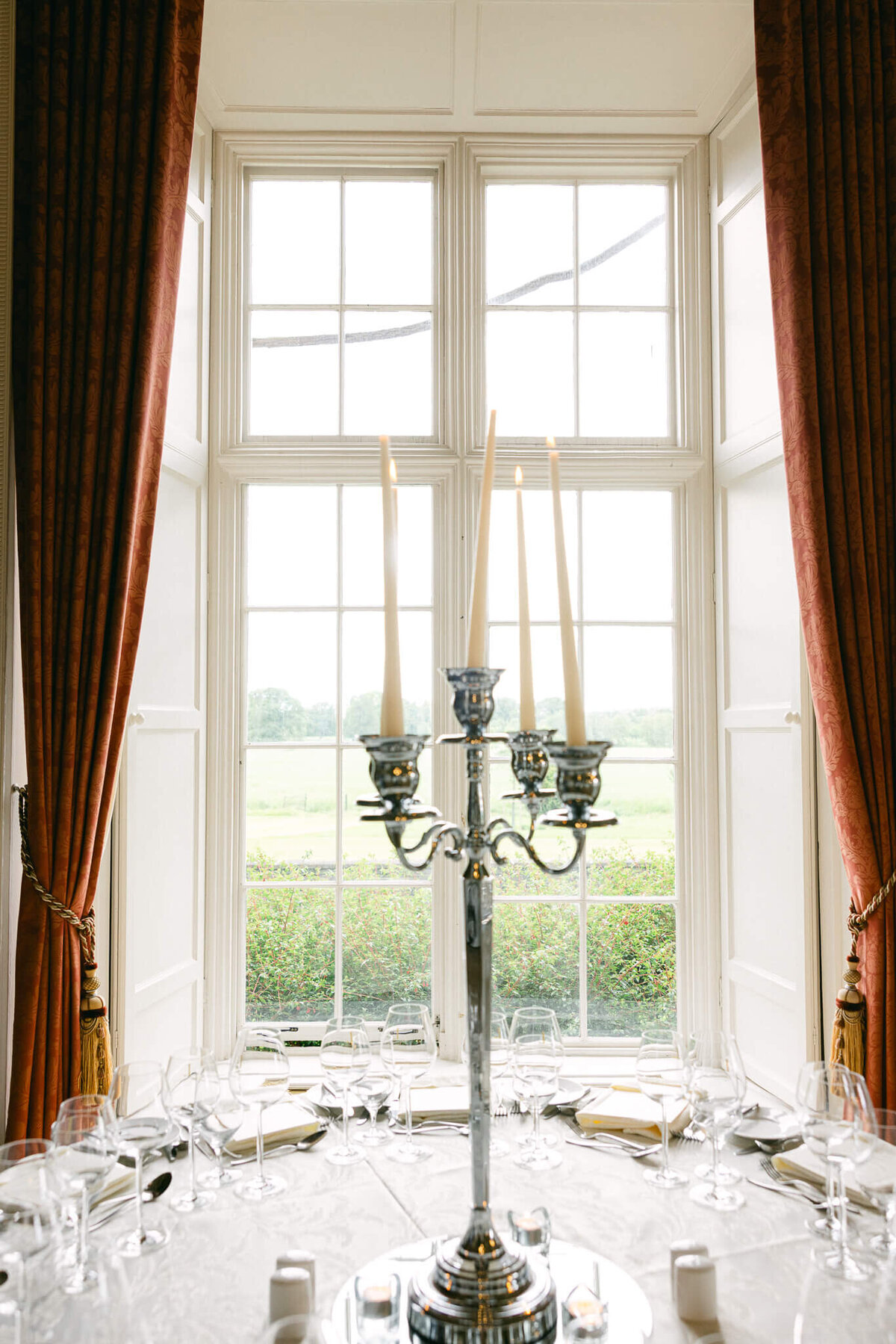 A wedding photo of a dinner table with candles on it at Luttrellstown Castle in Ireland