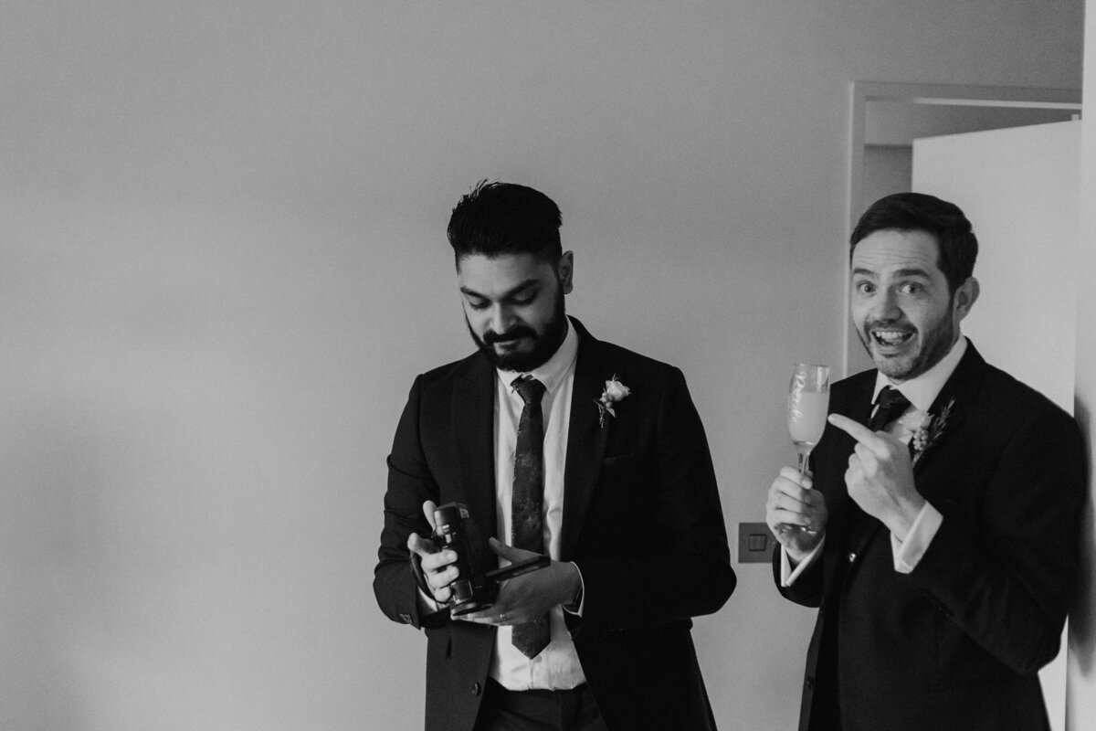 groom and groomsman laughing