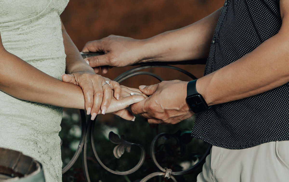 Riverside Hands Holding Engagement Railing