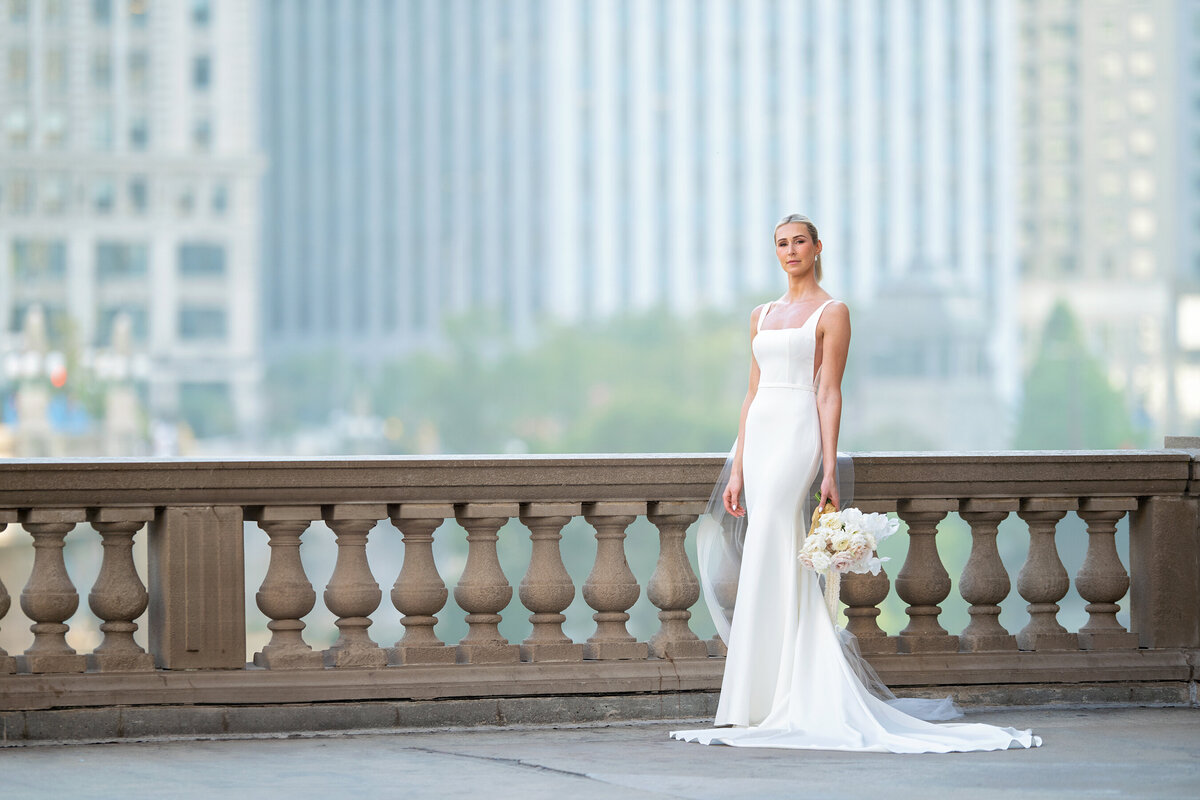 luxurious  wedding  picture by the Wrigley building of a stunning  tall bride