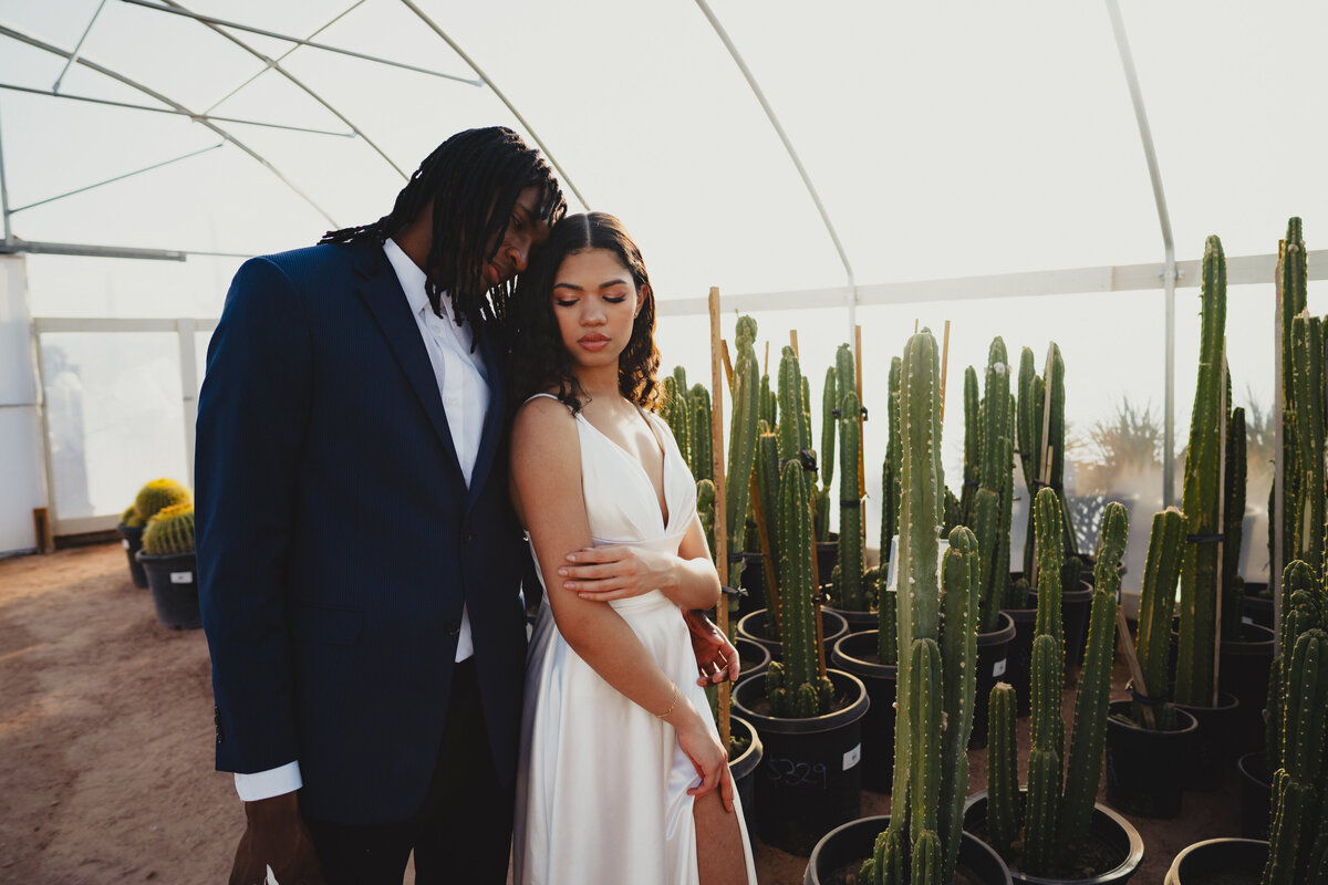Wedding Photography: Bride and groom in a greenhouse.