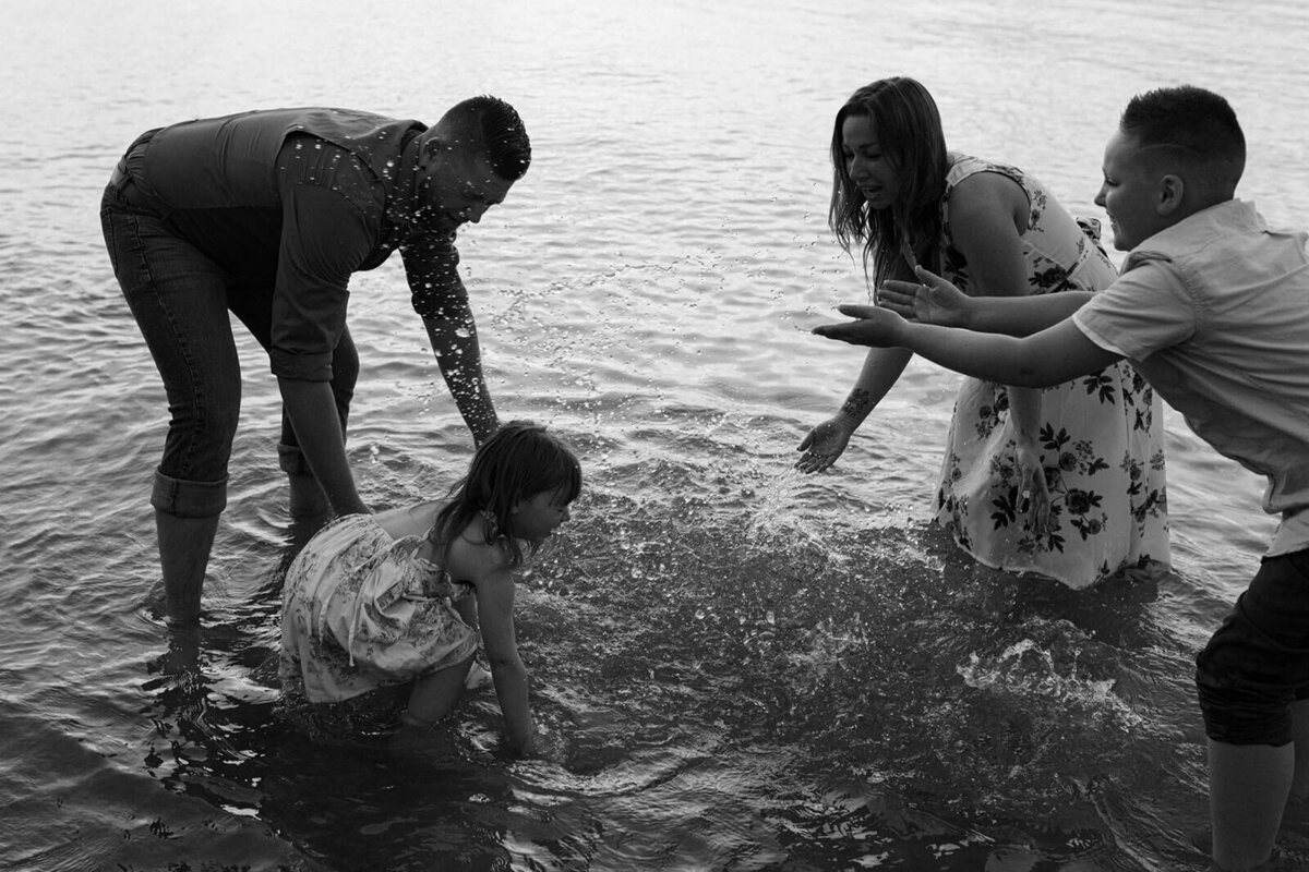 family with two kids on the beach at family photo shoot in Finger Lakes, NY