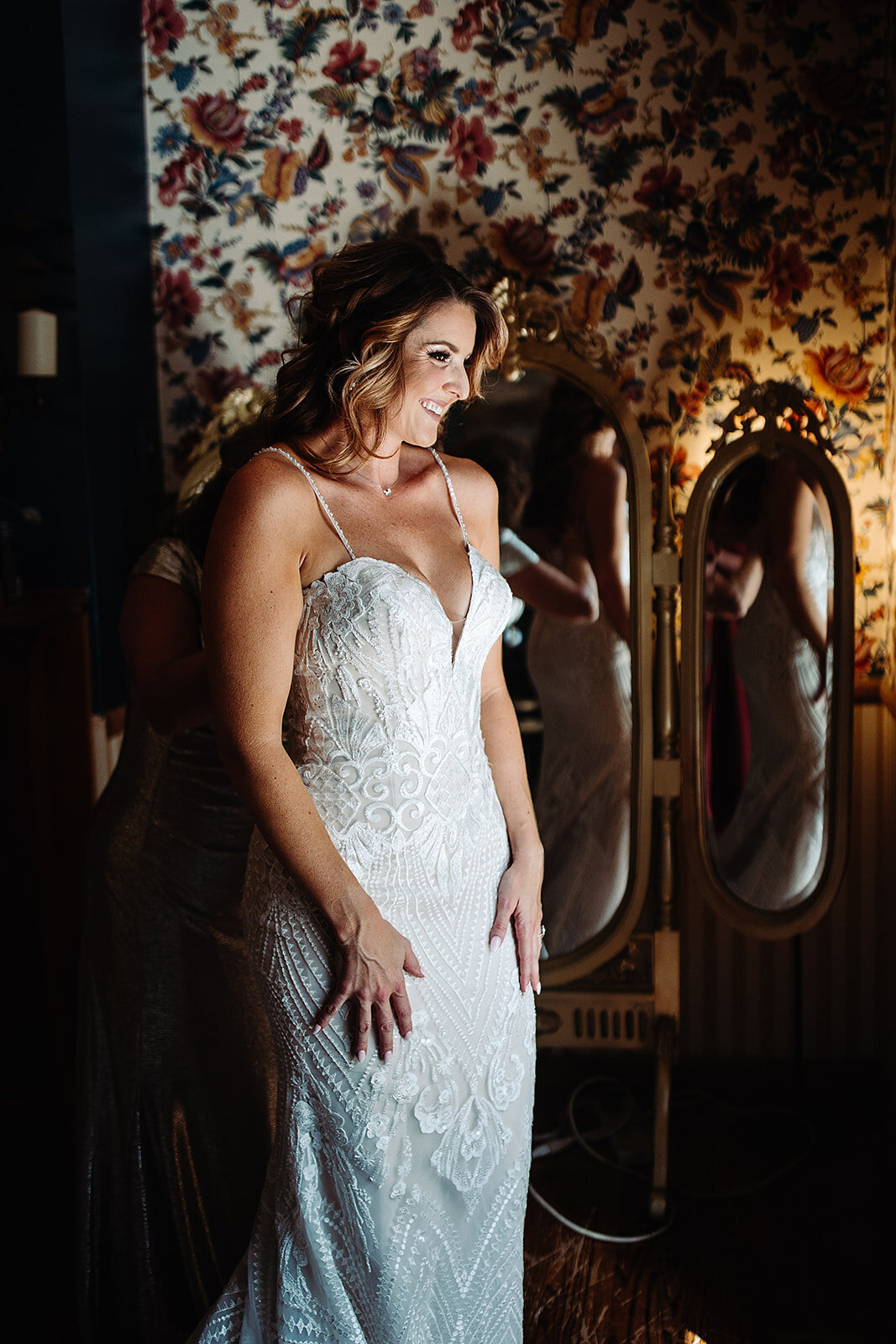 Bride gets a first look at herself ready for her wedding.
