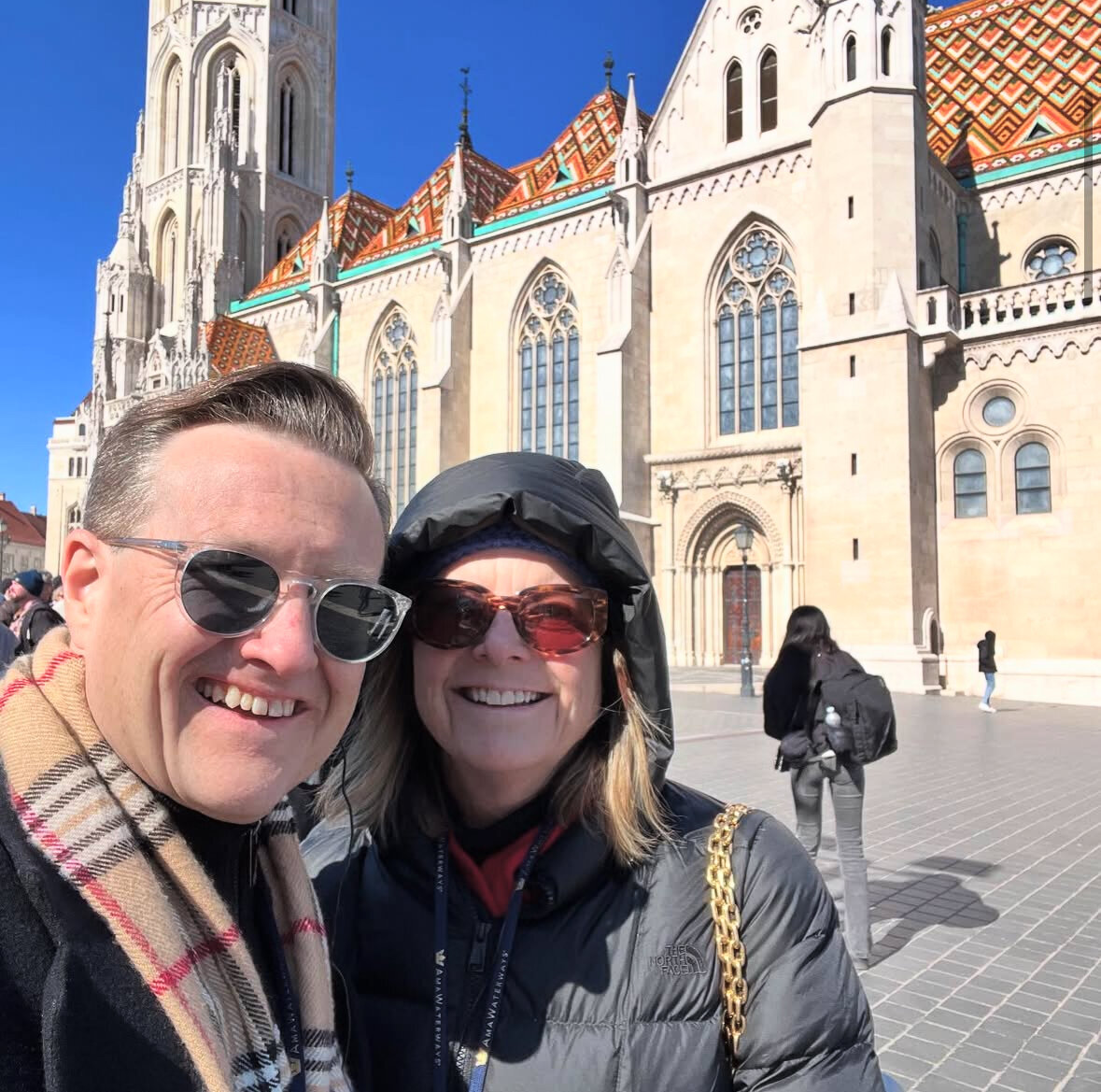 Jason and Kelly in Europe next to pretty building with windows
