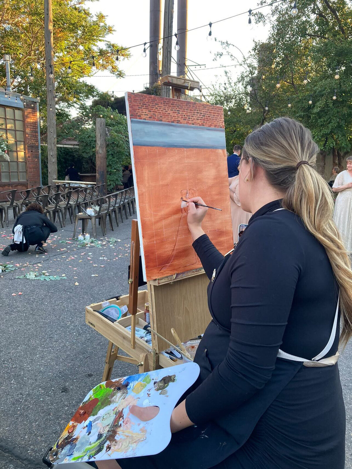 A live wedding artist works on a piece at the venue Blanc in denver