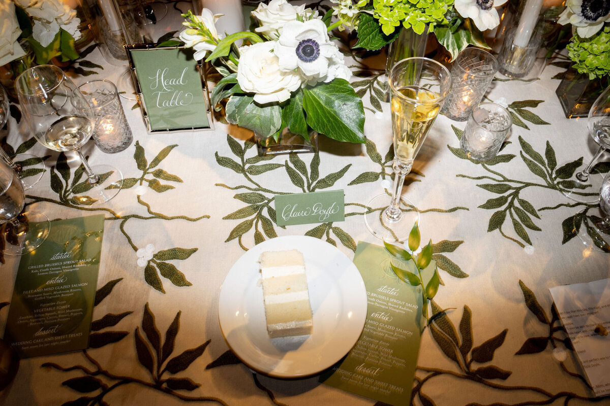 Photo of a slice of wedding cake on a plate at the reception. 
