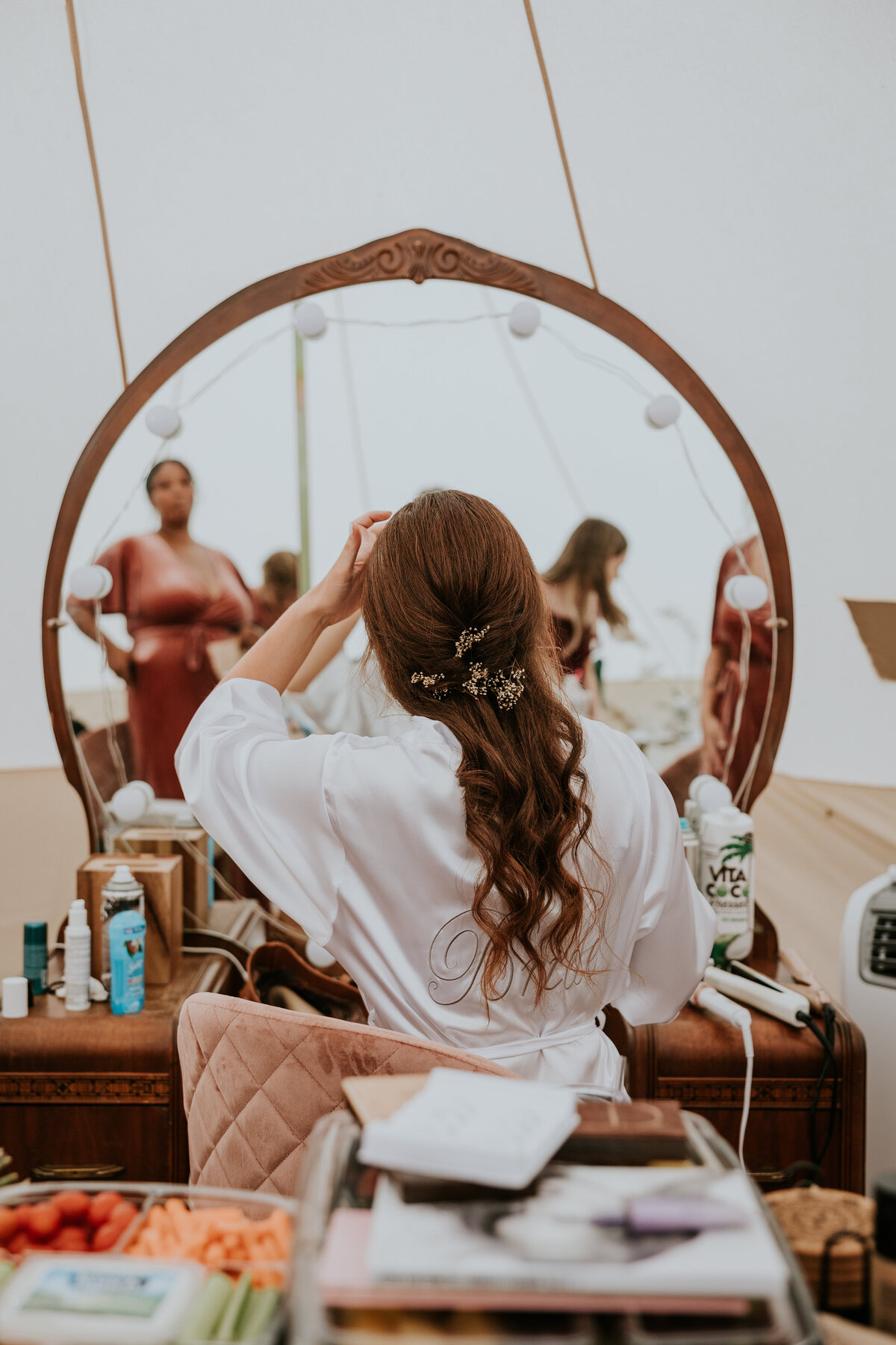 Bride gets ready in front of mirror at Firebrand Cocolalla
